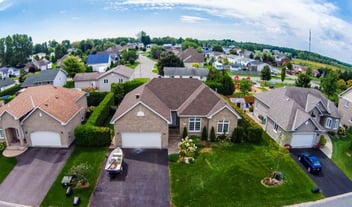 Ariel shot of a residential neighborhood with a boat in the driveway